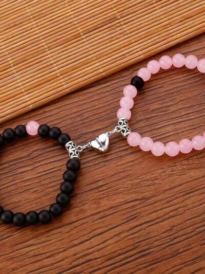 A Pair Of Pink And Black Beaded Bracelets, Perfect For Couples' Daily Wear Or As A Gift For Friends.